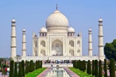 Taj Mahal'in beyaz mermer kubbesi ve Agra'daki bahçe manzarası