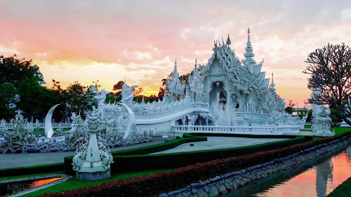 Chiang Rai'deki Beyaz Tapınak'ın gün ışığında görünümü ve çevresindeki ağaçlar