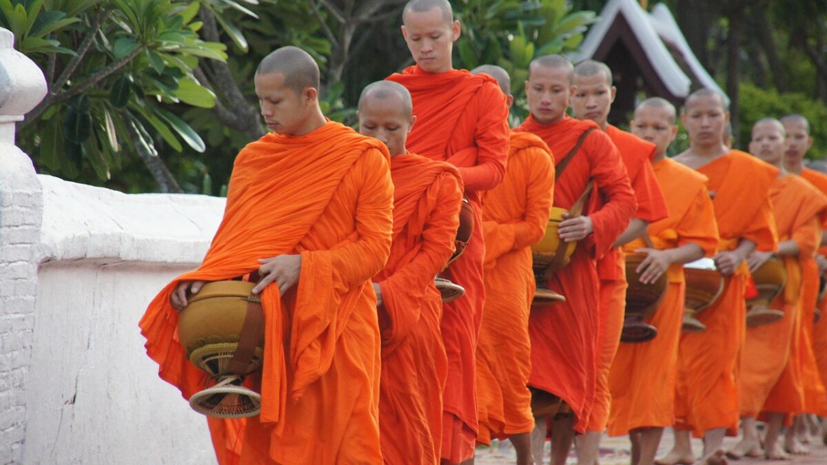 Laos'ta gezilecek yerler arasında yer alan Luang Prabang'da sabah sisi içinde tapınak ve nehir manzarası