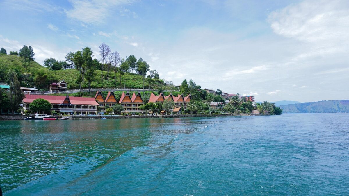 Sumatra'da Toba Gölü ve Samosir Adası'nın yeşil yamaçlarla çevrili manzarası