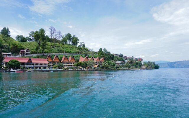 Sumatra'da Toba Gölü ve Samosir Adası'nın yeşil yamaçlarla çevrili manzarası